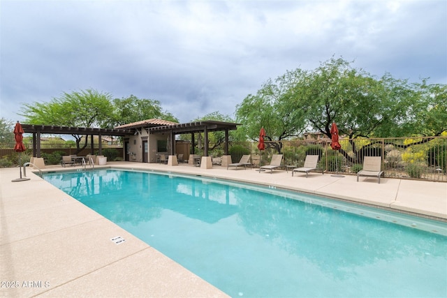 pool featuring a pergola, a patio area, and fence