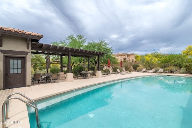 community pool featuring fence, a pergola, and a patio