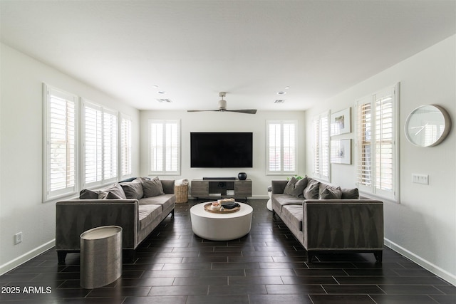 living area with visible vents, a ceiling fan, baseboards, and wood tiled floor