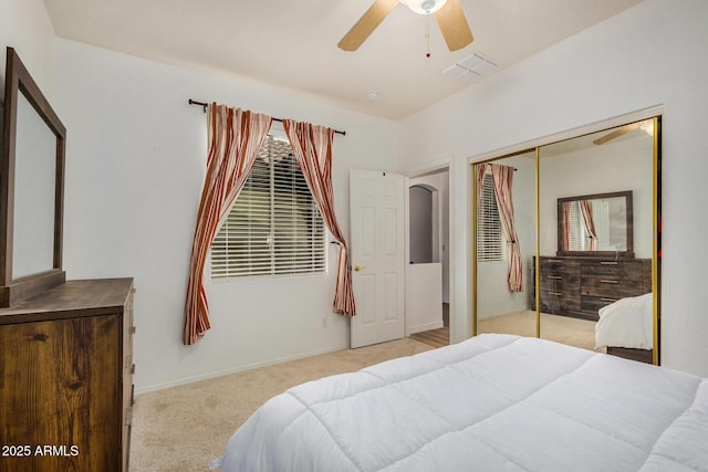 carpeted bedroom featuring ceiling fan and a closet