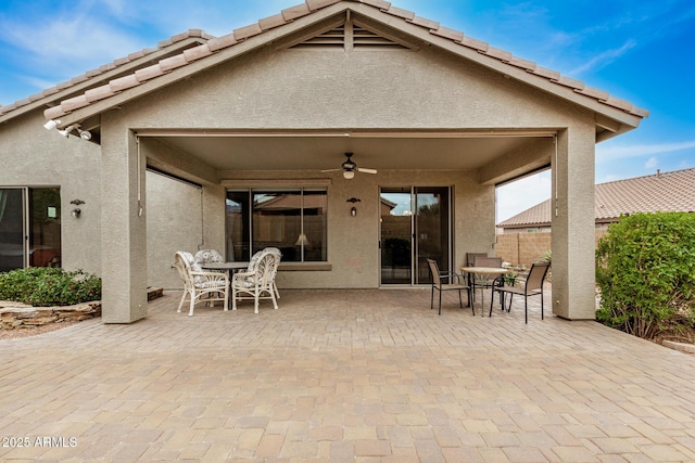 back of house with ceiling fan and a patio area