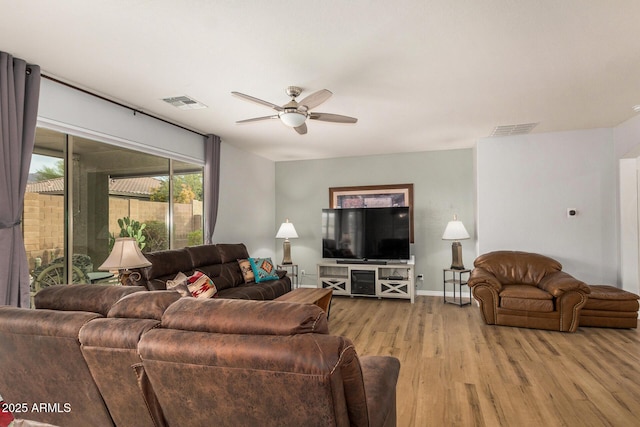 living room featuring ceiling fan and light wood-type flooring