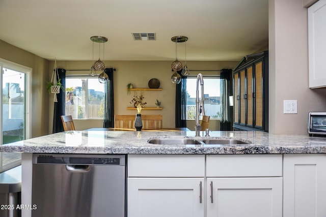 kitchen with white cabinets, stainless steel dishwasher, pendant lighting, and sink