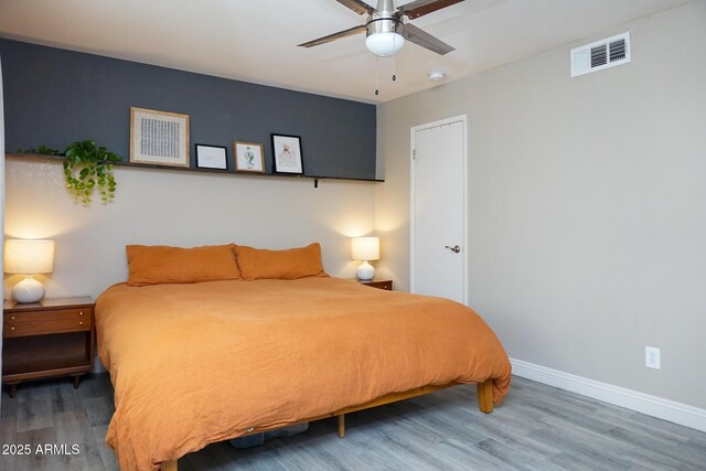 bedroom with ceiling fan and wood-type flooring