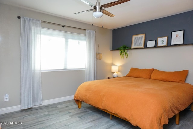 bedroom with ceiling fan and light hardwood / wood-style floors