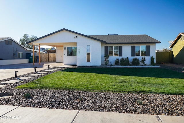 ranch-style home featuring a carport and a front lawn