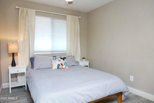 bedroom featuring multiple windows and wood-type flooring