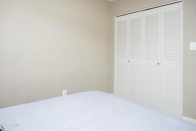 unfurnished bedroom with a closet