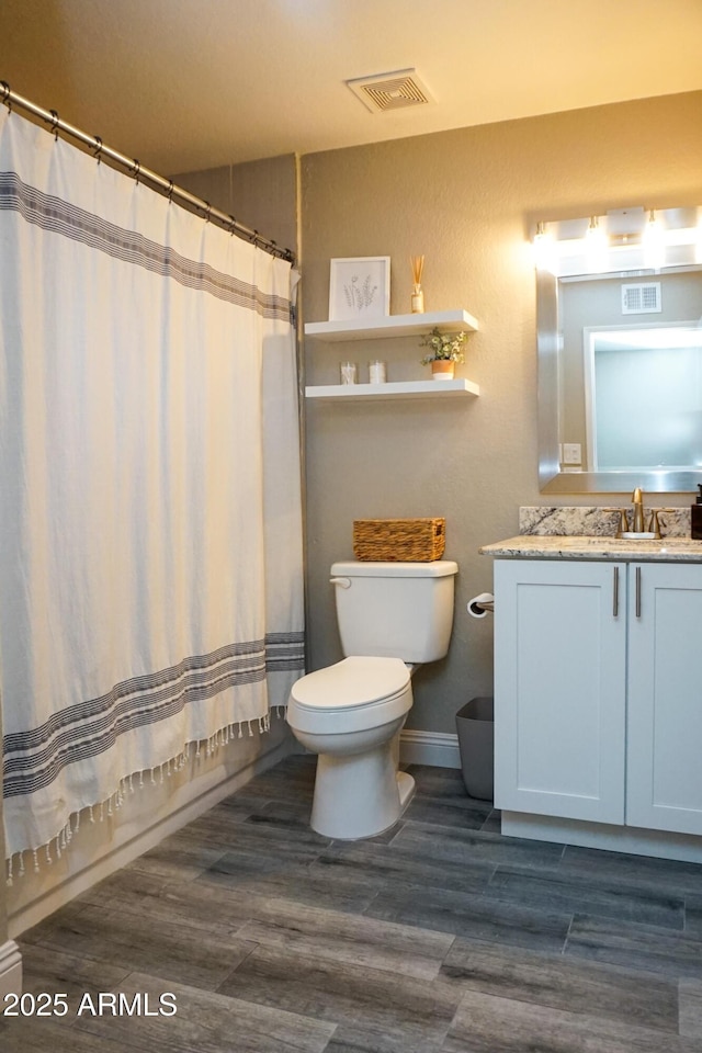 full bathroom with toilet, wood-type flooring, vanity, and shower / bath combination with curtain