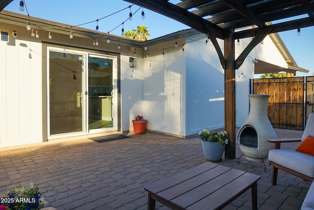 view of patio / terrace featuring an outdoor fireplace and a pergola