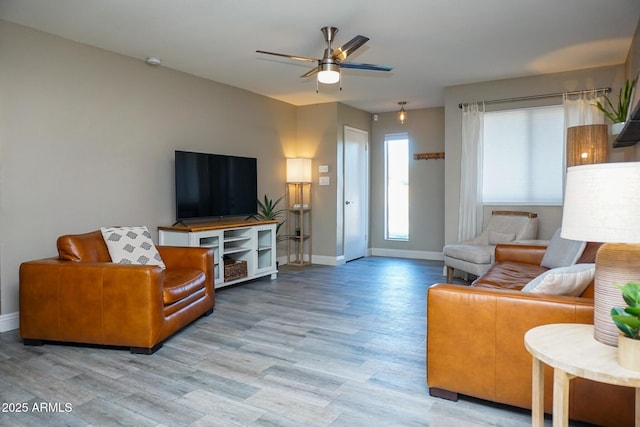 living room featuring light hardwood / wood-style floors and ceiling fan