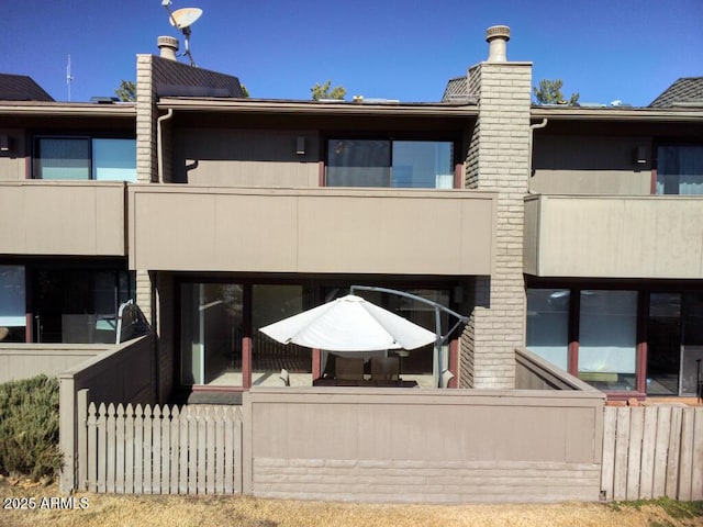 3340 W State Route 89a Unit 9, Sedona, AZ 86336 - rear view of property with a chimney and a balcony