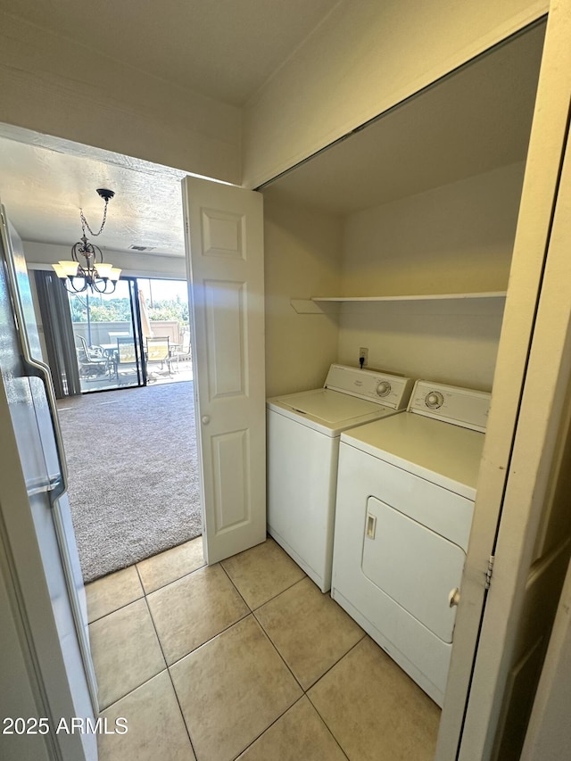3340 W State Route 89a Unit 9, Sedona, AZ 86336 - washroom featuring washing machine and dryer, light tile patterned floors, light carpet, and a chandelier