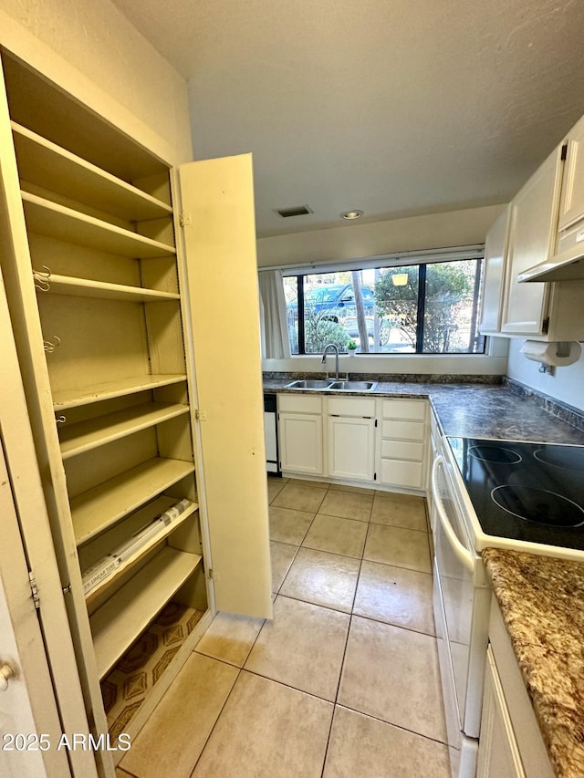 3340 W State Route 89a Unit 9, Sedona, AZ 86336 - kitchen with white appliances, a sink, white cabinets, light tile patterned floors, and under cabinet range hood