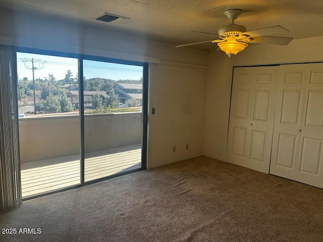 3340 W State Route 89a Unit 9, Sedona, AZ 86336 - unfurnished bedroom with carpet, access to outside, a textured ceiling, ceiling fan, and a closet