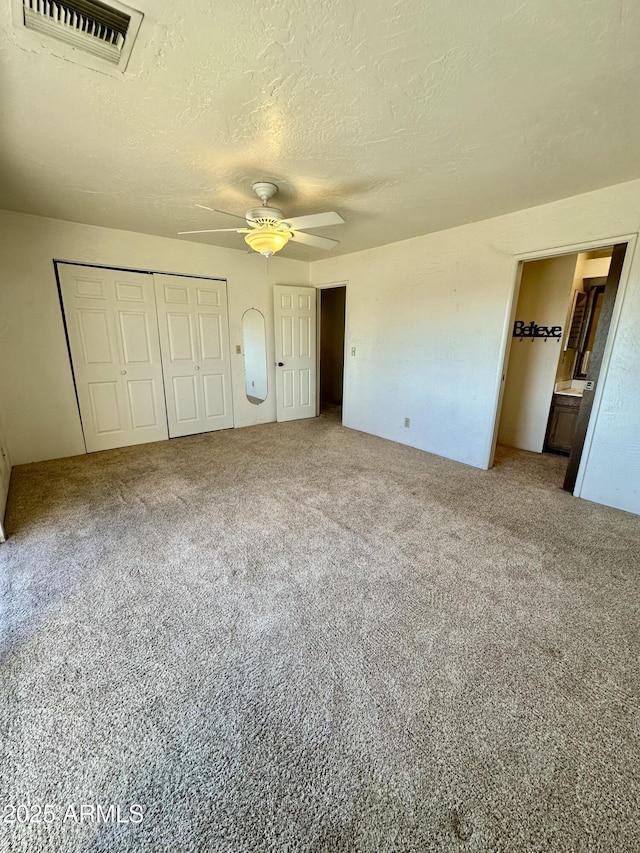 3340 W State Route 89a Unit 9, Sedona, AZ 86336 - unfurnished bedroom featuring carpet flooring, a ceiling fan, and a textured ceiling