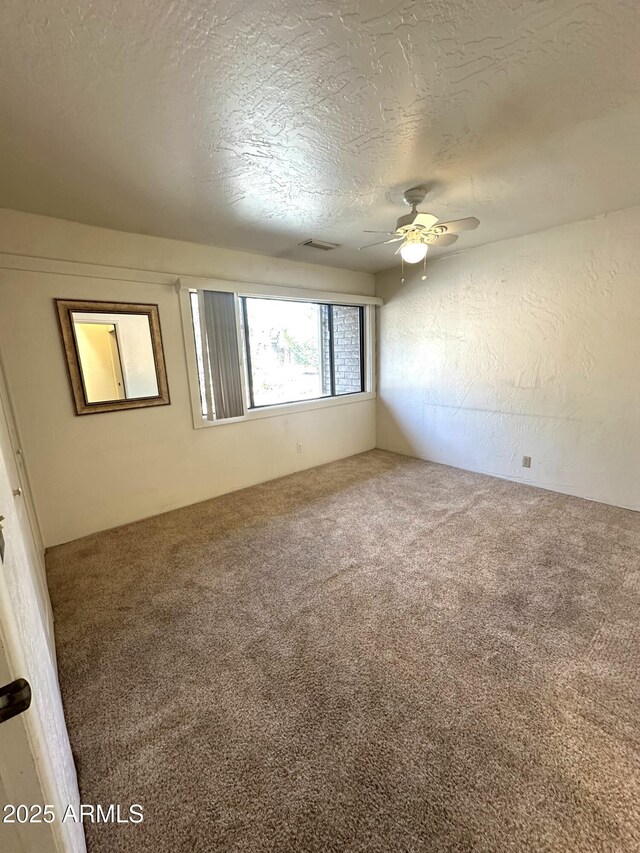 3340 W State Route 89a Unit 9, Sedona, AZ 86336 - carpeted spare room with a ceiling fan and a textured ceiling