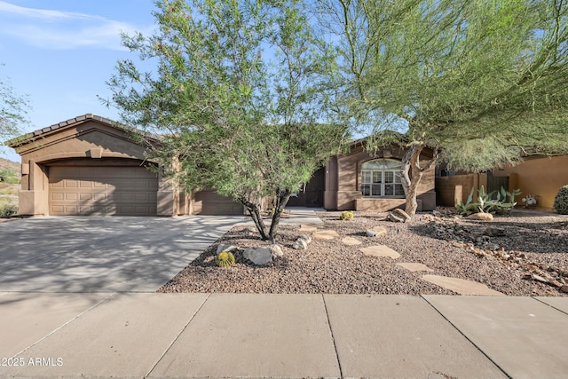 13945 E Gail Rd, Scottsdale, AZ 85259 - view of front facade with a garage, driveway, and stucco siding