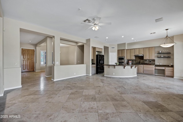 13945 E Gail Rd, Scottsdale, AZ 85259 - kitchen with freestanding refrigerator, stainless steel microwave, dark countertops, backsplash, and ceiling fan