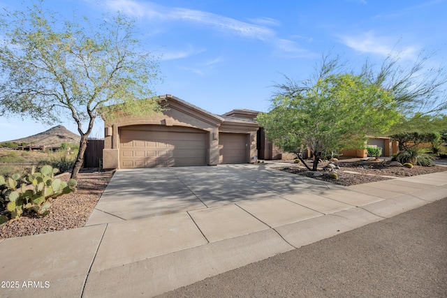13945 E Gail Rd, Scottsdale, AZ 85259 - view of front of property featuring a garage, driveway, and stucco siding