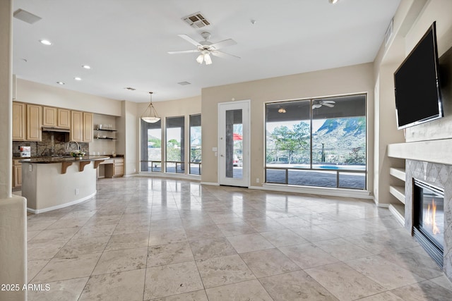 13945 E Gail Rd, Scottsdale, AZ 85259 - unfurnished living room featuring a ceiling fan, a glass covered fireplace, light tile patterned flooring, and recessed lighting