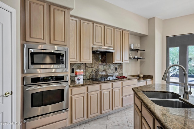 13945 E Gail Rd, Scottsdale, AZ 85259 - kitchen with appliances with stainless steel finishes, light brown cabinetry, under cabinet range hood, backsplash, and dark stone countertops