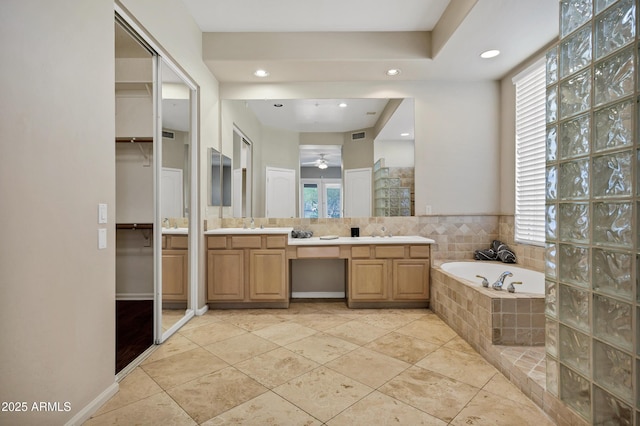 13945 E Gail Rd, Scottsdale, AZ 85259 - full bathroom featuring healthy amount of natural light, double vanity, a garden tub, a ceiling fan, and recessed lighting
