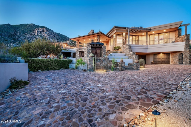 11070 E Rolling Rock Dr, Scottsdale, AZ 85262 - exterior space with stucco siding, stone siding, a balcony, a mountain view, and a garage