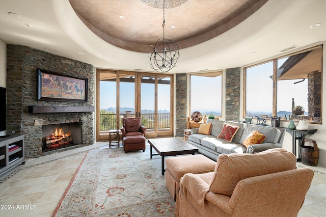 11070 E Rolling Rock Dr, Scottsdale, AZ 85262 - living room with visible vents, an inviting chandelier, a fireplace, and a raised ceiling