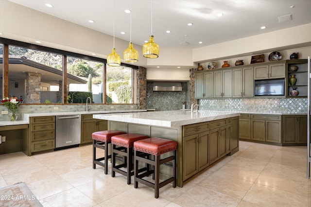 11070 E Rolling Rock Dr, Scottsdale, AZ 85262 - kitchen featuring dishwasher, a center island with sink, backsplash, and pendant lighting