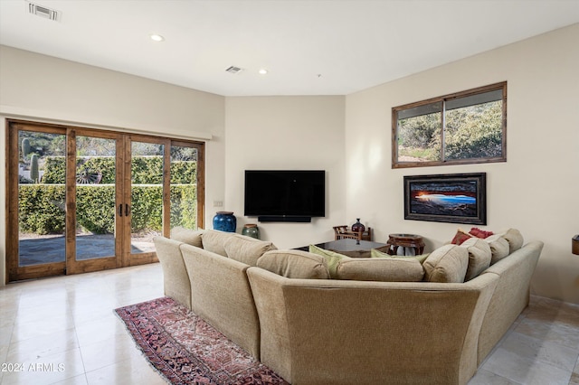 11070 E Rolling Rock Dr, Scottsdale, AZ 85262 - living room with french doors, recessed lighting, a glass covered fireplace, and visible vents