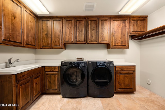 11070 E Rolling Rock Dr, Scottsdale, AZ 85262 - clothes washing area with washer and clothes dryer, visible vents, cabinet space, and a sink