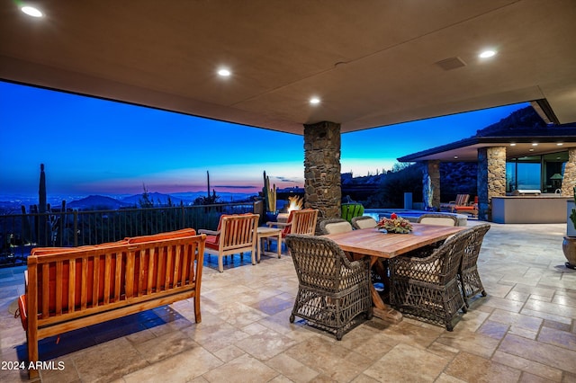 11070 E Rolling Rock Dr, Scottsdale, AZ 85262 - patio terrace at dusk with area for grilling, fence, and outdoor dining space