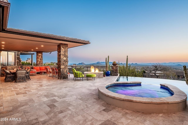 11070 E Rolling Rock Dr, Scottsdale, AZ 85262 - view of swimming pool with an outdoor living space with a fire pit, an in ground hot tub, a mountain view, and a patio