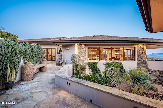 11070 E Rolling Rock Dr, Scottsdale, AZ 85262 - exterior space featuring a tile roof, stucco siding, stone siding, and french doors