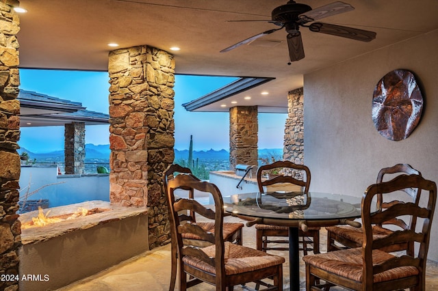 11070 E Rolling Rock Dr, Scottsdale, AZ 85262 - dining area featuring a ceiling fan, stone finish floor, and a mountain view