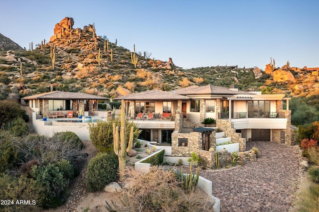 11070 E Rolling Rock Dr, Scottsdale, AZ 85262 - rear view of house featuring a sunroom, stairway, stone siding, a gazebo, and a patio area