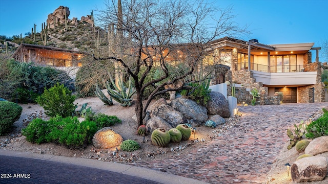 11070 E Rolling Rock Dr, Scottsdale, AZ 85262 - view of home's exterior featuring stone siding, a balcony, and stucco siding