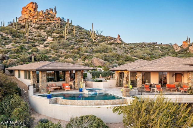 11070 E Rolling Rock Dr, Scottsdale, AZ 85262 - view of swimming pool featuring a pool with connected hot tub, an outdoor living space, and a patio area
