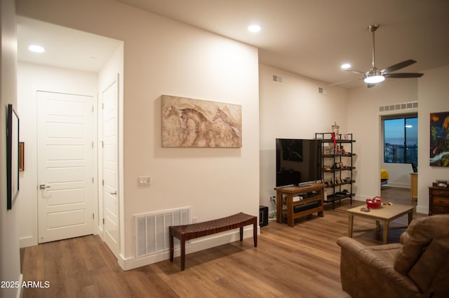 living room featuring ceiling fan and hardwood / wood-style floors