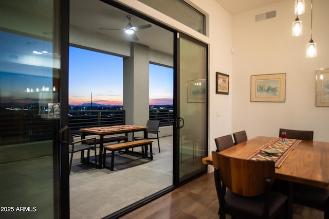 dining area with hardwood / wood-style flooring and ceiling fan