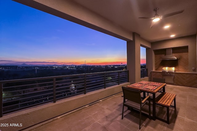 patio terrace at dusk with exterior kitchen, grilling area, and ceiling fan