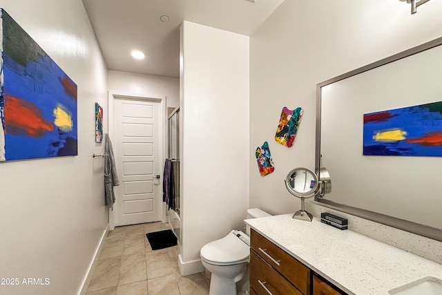 bathroom with toilet, vanity, a shower with shower door, and tile patterned floors