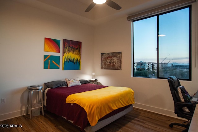 bedroom featuring ceiling fan and dark wood-type flooring