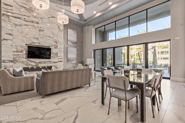 dining room featuring a towering ceiling and a chandelier