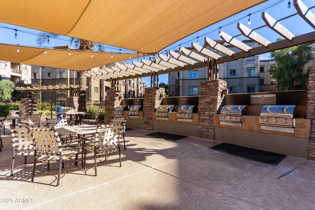 view of patio / terrace featuring a pergola, area for grilling, and exterior kitchen