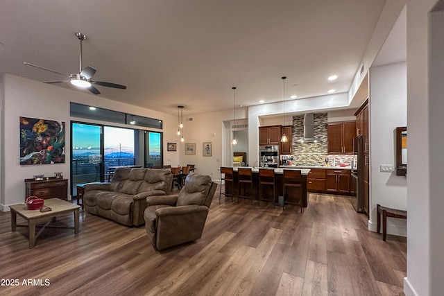 living room with ceiling fan and dark hardwood / wood-style floors