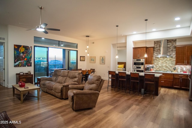 living room featuring ceiling fan and hardwood / wood-style floors