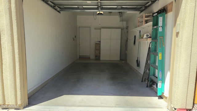 7675 E Mcdonald Dr Unit 107, Scottsdale, AZ 85250 - garage featuring baseboards and a garage door opener
