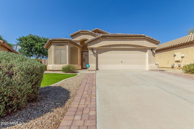 29049 N Coal Ave, San Tan Valley, AZ 85143 - mediterranean / spanish-style home featuring a garage, stucco siding, and driveway